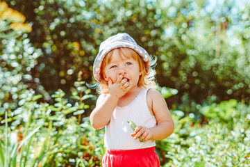 child in the garden with berries
