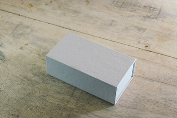 close up of a white box template on wood background, mock up design