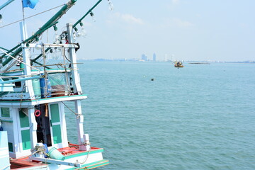 View of the fishing port overlooking the boat and Pattaya city. Which is a large city close to local fishing sources in Thailand