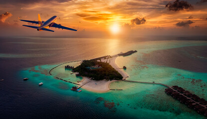 Travel concept with an airplane flying towards a tropical paradise island in the Maldives during...