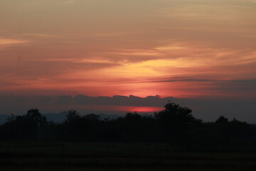 Fototapeta na wymiar Golden light of Sunrise and silhouette in the morning