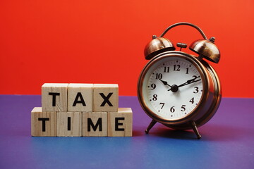 Tax Time alphabet letter with alarm clock on blue and red background