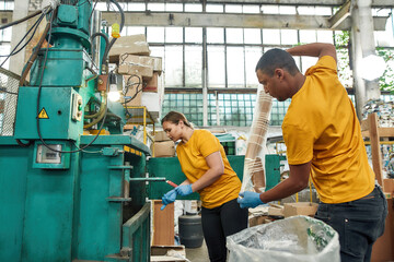 Man and girl throwing cups into rubbish pressing machine