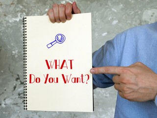 Business concept meaning WHAT Do You Want? with sign on the page.