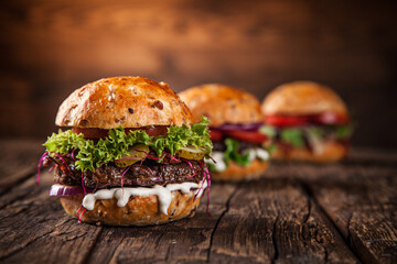 Close-up of home made burgers on wooden background
