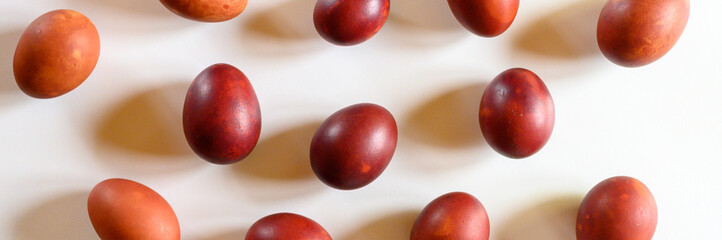 easter eggs painted onion husks on a white background. coloring the eggs according to the old natural eco-friendly method with peeled onions. banner
