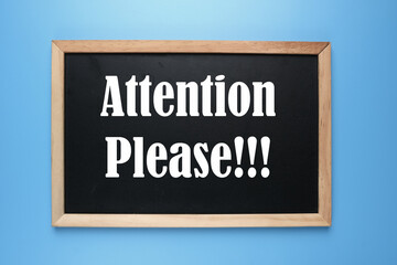 A picture of  blackboard written Attention Please on blue background.