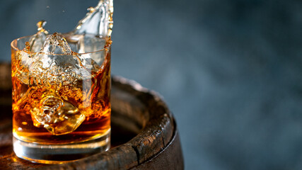Ice Cube falling into Glass of Whisky, Freeze Motion.