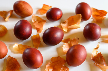 easter eggs painted onion husks on a white background. coloring the eggs according to the old natural eco-friendly method with peeled onions