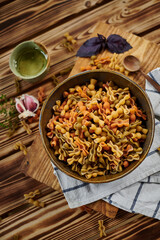 noodles in bowl with garlic and olive oil on wooden table covered with white cloth