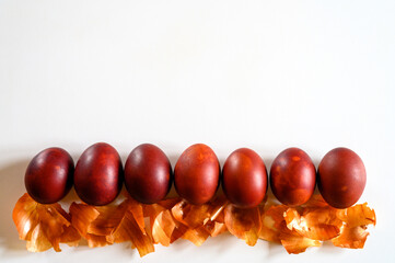 easter eggs painted onion husks on a white background. coloring the eggs according to the old natural eco-friendly method with peeled onions. space for text