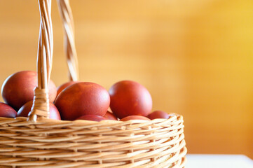easter egg painted onion husks in a wicker wooden basket. coloring the eggs according to the old eco-friendly method with peeled onions. going to celebrate easter. flare. selective focus
