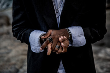Closeup shot of the hands of a stylish African American male with rings