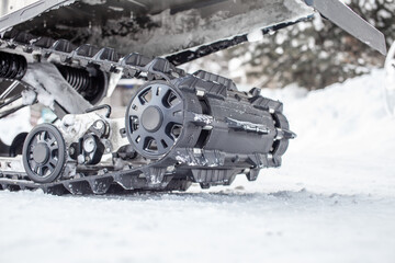 Rear suspension of a snowmobile in winter. Riding on a snowmobile