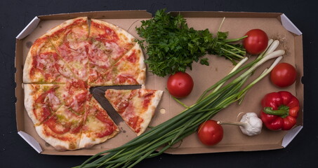 Tasty pizza and fresh vegetables