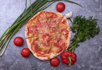 Tasty pizza and fresh vegetables