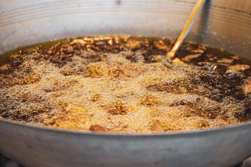 Food concept. Boiling oil in metal bowl in Thailand fresh food market
