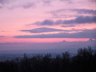Obraz premium profile of the Monviso alp overlooks the Po Valley immersed in a pink sky
