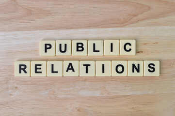 Top view of alphabet letters with text PUBLIC RELATIONS. Business concept.
