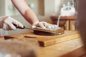 Female hands cut the cake of the future cake
