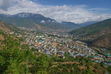 Fototapeta na wymiar Landscape view of Thimphu the capital of Bhutan surrounded by mountains and forest