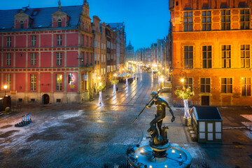 Neptune Fountain and a Christmas decorations in snowy old town of Gdańsk. Poland