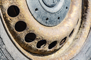 Old rusty car wheel rim closeup