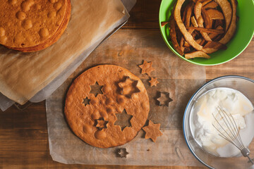 Bakery ingredients and kitchen utensils on wooden rural kitchen table for baking thematic background.