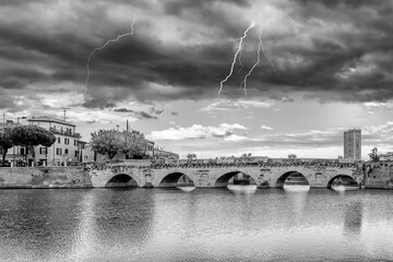 Black and white view of the ancient Bridge of Augustus and Tiberius in the historic center of...