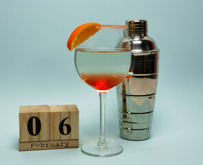 calendar february 6 day of the barman. cocktail and shaker on blue background