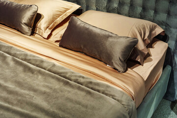 Fragment of a bed in retro style. Soft green back and beige linens. Close-up