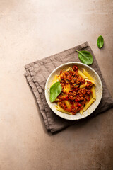 Overhead view of penne pasta with bolognese
