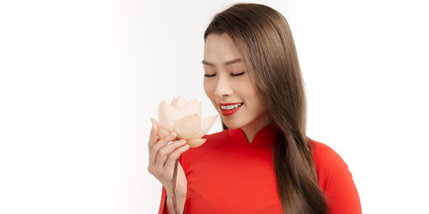 Beautiful vietnamese girls dressed traditional Ao Dai red dress. Vietnamese girl holding a lotus flower