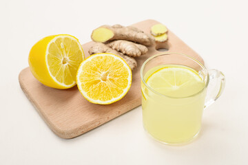 Cup of lemon ginger lemonade and ingredients on cutting board