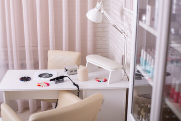 Working place for nail care master in beauty salon. Modern design and interior.