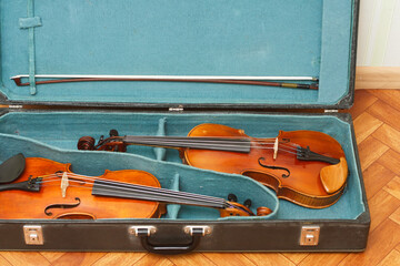 Naklejka na ściany i meble Two classical violins with bows in a double case 