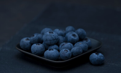 Ripe blueberries on a dark background