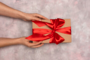 blurred hands with a gift