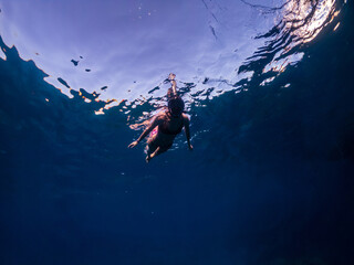 Young woman swim in Red Sea in snorkeling mask