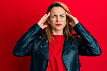 Hispanic young woman wearing black leather jacket with hand on head, headache because stress....