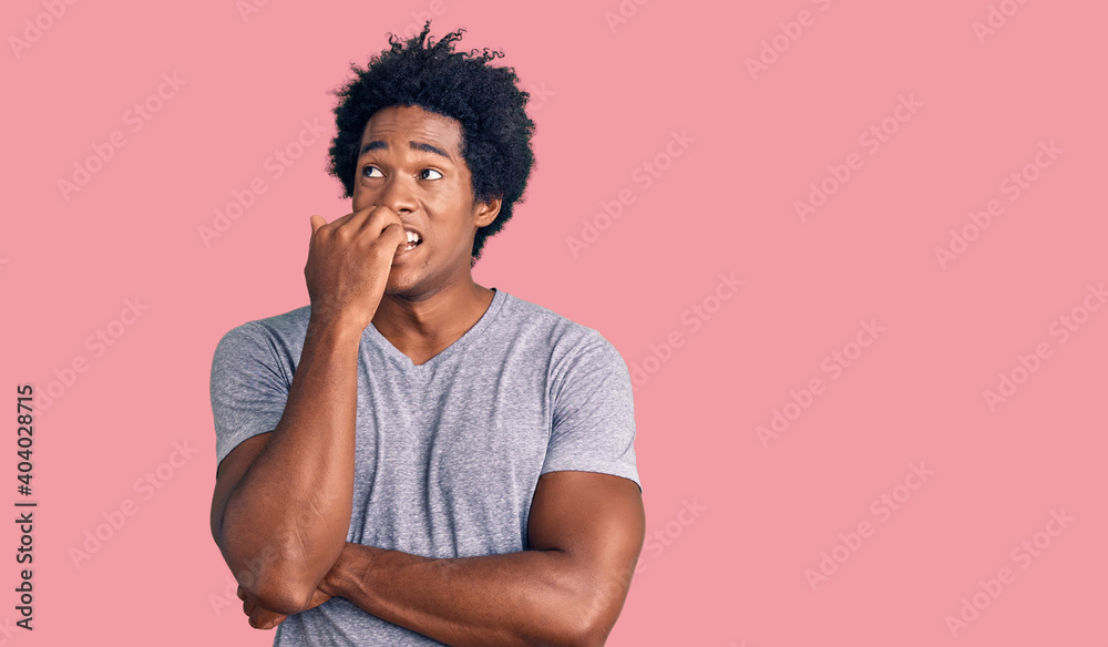 Poster handsome african american man with afro hair wearing casual clothes looking stressed and nervous wit