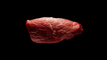 Raw Beef Steak Piece On A Black Surface, Top view