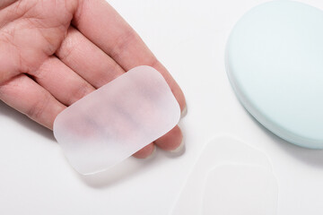 Woman hand holds portable Bath Disposable Soap Sheets, Mini Paper Soap