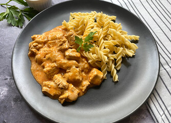 Classic chicken goulash with fusilli pasta in sour creme gravy and served with gherkins. 