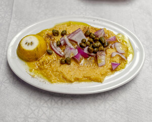 traditional fava smashed beans puree dish with capers, onions and origan
