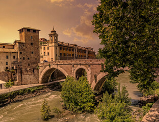 sunset in Rome Italy, view of Tiber island, bridge Fabricio and Caetani fortress tower    ..