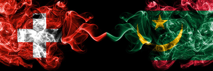 Switzerland, Swiss vs Mauritania smoky mystic flags placed side by side. Thick colored silky abstract smoke flags.