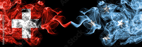 Switzerland, Swiss vs Micronesia smoky mystic flags placed side by side. Thick colored silky abstract smoke flags.