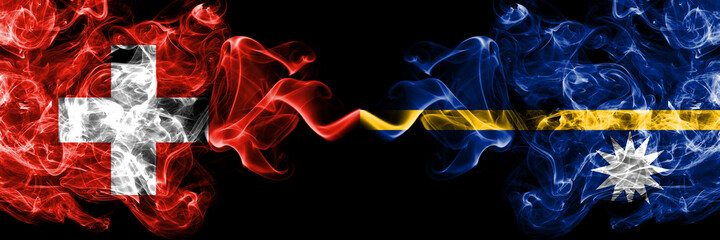 Switzerland, Swiss vs Nauru, Nauruan smoky mystic flags placed side by side. Thick colored silky abstract smoke flags.