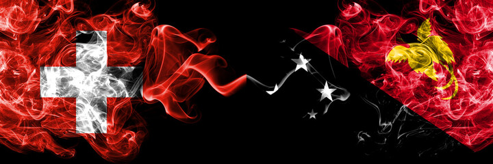 Switzerland, Swiss vs Papua New Guinea smoky mystic flags placed side by side. Thick colored silky abstract smoke flags.